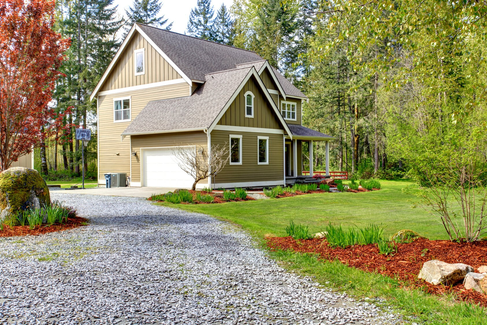 Countryside house exterior. View of entrance and gravel driveway